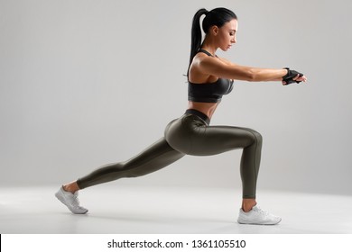 Fitness Woman Doing Lunges Exercises For Leg Muscle Workout Training. Active Girl Doing Front Forward One Leg Step Lunge Exercise