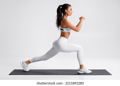 Fitness woman doing lunges exercises for leg muscle training. Active girl doing front forward one leg step lunge exercise - Shutterstock ID 2211892283