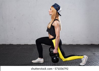 Fitness Woman Doing Lunges With Kettlebells In Hands