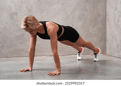 Fitness woman doing plank exercise workout in gym indoors. Straight arm plank exercise to strengthen the cortex. Fitness, sports, healthy lifestyle. - Powered by Shutterstock