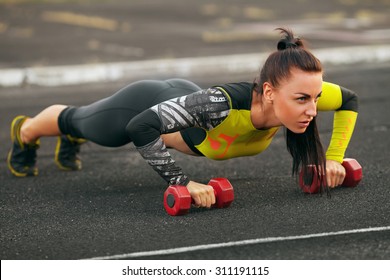 Fitness Woman Doing Push-ups In The Stadium, Cross Training Workout. Sporty Girl Outside