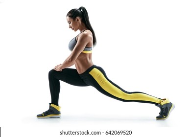 Fitness Woman Doing Stretching Workout. Full Length Shot Of Young Woman On White Background. Stretching And Motivation