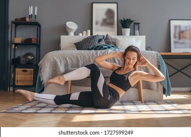 Fitness Woman Doing Twists Exercise. Morning Workout At Home