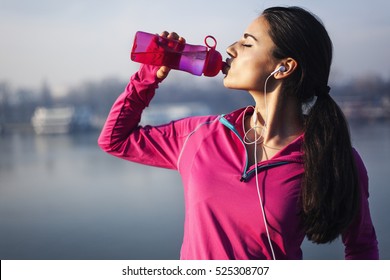 Fitness woman drinking water  - Shutterstock ID 525308707