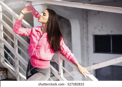 Fitness Woman Drinking Water After Jogging On Metal Steps