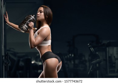 Fitness Woman Drinking Water At Workout In The Gym. Pretty Caucasian Girl Exercising Cross Fitness And Bodybuilding Sport Concept. Abs Muscle Butt  And Booty Exercises In Gym Naked Torso