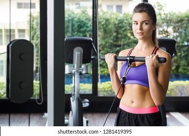 Fitness Woman During Arms Workout In The Gym. Standing Biceps Cable Curl Exercise.