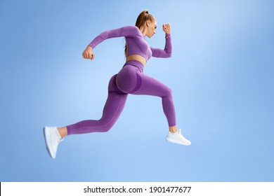 Fitness woman jumping and running, working out. Athletic girl doing jump