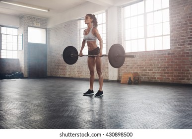 Fitness Woman Preparing To Practice Deadlift With Heavy Weights In Gym. Female Doing Heavy Weight Lifting Work Out In Health Club.