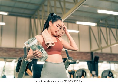 Fitness Woman Resting From Excersise In The Gym And Drinking Water From Bottle.