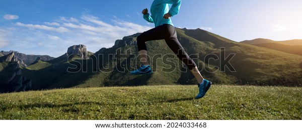 Fitness woman runner\
running at mountain top