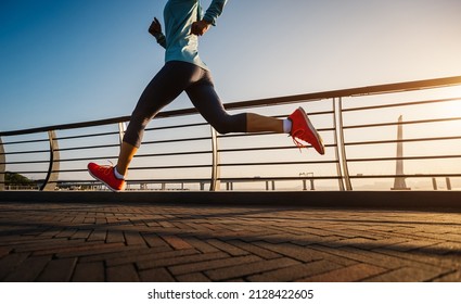 Fitness woman runner running on seaside bridge - Shutterstock ID 2128422605
