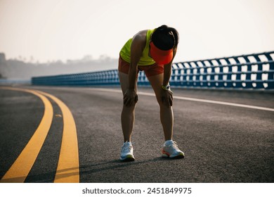 Fitness woman runner running on seaside bridge - Powered by Shutterstock