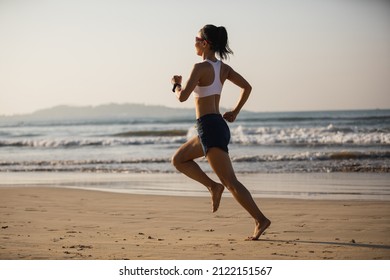 Fitness woman running on beach  - Powered by Shutterstock