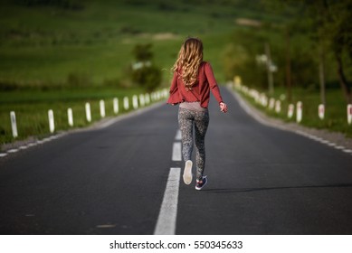 Fitness Woman Running On The Country Road