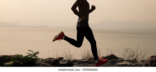 Fitness Woman Running On Winter Coast