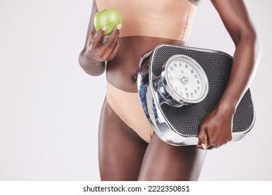 Fitness Woman, Scale And Apple For Healthy Diet, Exercise Progress And Wellness Nutrition On Studio Background. Scales, Fruit And Black Model Measure Body For Weightloss Training, Muscle And Beauty