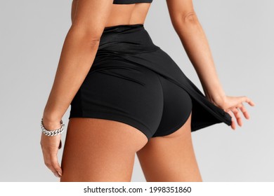 Fitness woman in sportswear. Sporty booty in shorts