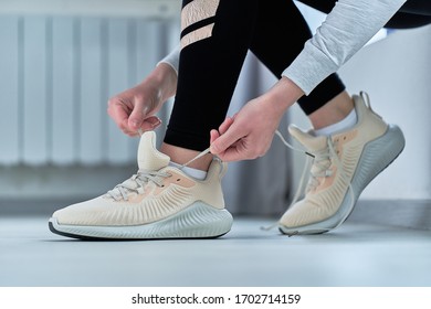 Fitness woman ties shoelaces on sneakers and get ready for jogging and workout. Do sport and be fit. Sports people with healthy sporty lifestyle     - Powered by Shutterstock