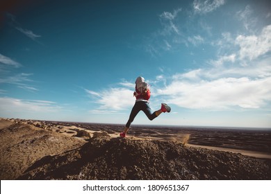 Fitness woman trail runner cross country running  on sand desert dunes - Powered by Shutterstock