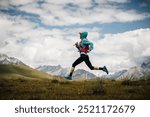 Fitness woman trail runner running in grassland