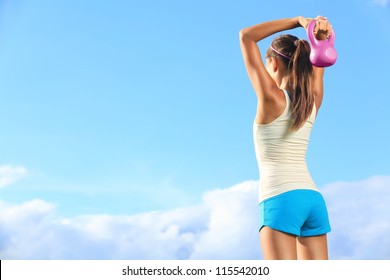 Fitness Woman Using Kettlebells Outside During Fitness Strength Training Against Copyspace.