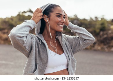 Fitness Woman Wearing A Hooded Shirt Walking Outdoors. Smiling Female On Early Morning Walk.