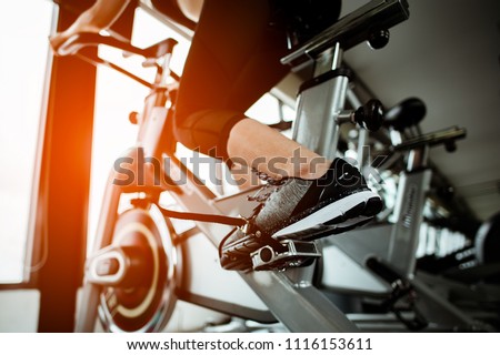 Fitness woman working out on exercise bike at the gym.exercising concept.fitness and healthy lifestyle 