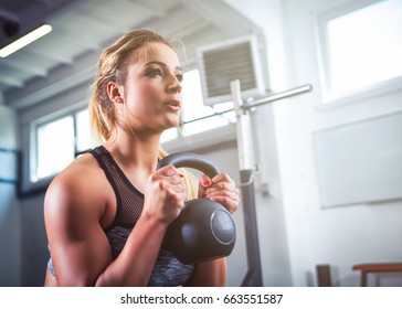 Fitness Woman Workout With Kettlebell Training At The Gym