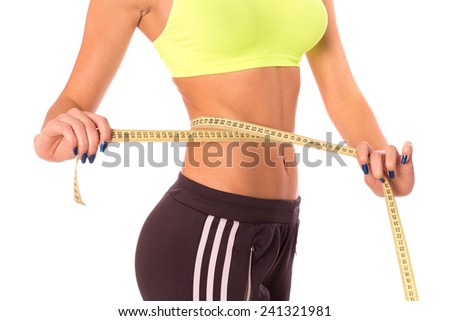Fitness woman's beautiful body with measure tape