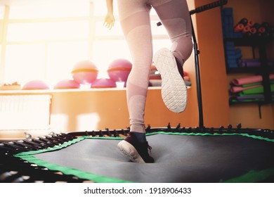 Fitness women jumping on mobile mini trampolines, workout gym movement.