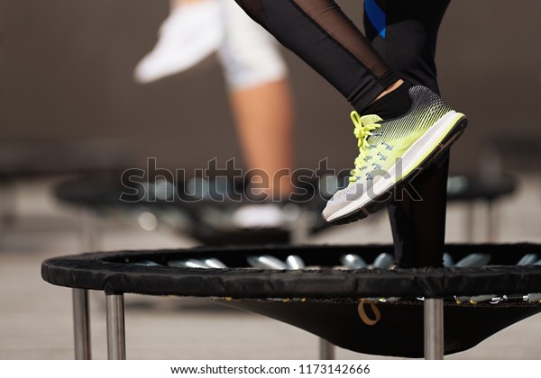 Fitness women jumping on small\
trampolines,exercise on\
rebounder