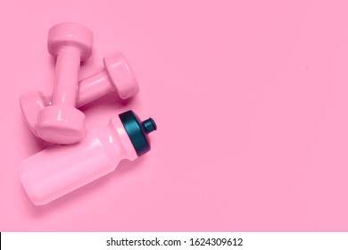 Fitness workout background concept with pink dumbbells and bottle of water. Top view flatlay sport, diet and healthy lifestyle with training equipment on pink background with blank copy space. - Shutterstock ID 1624309612