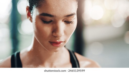 Fitness, workout and female athlete sweating in the gym after sports and strength training. Motivation, goals and woman doing a wellness and health exercise with focus in a sport center or studio. - Powered by Shutterstock