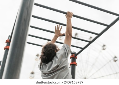 fitness workout on monkey bars outdoors, arm muscles training, climbing on ladder - Powered by Shutterstock