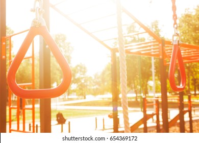 Fitness Workout At The Outdoor Gym In The Park. Sun Rays