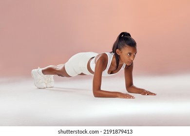 Fitness, Workout And Training Female Doing Plank Exercise Stay Healthy, Active And Strong. Fit, Slim And Athletic Woman Looking Serious While Doing Core And Ab Workout To Stay Active And In Shape