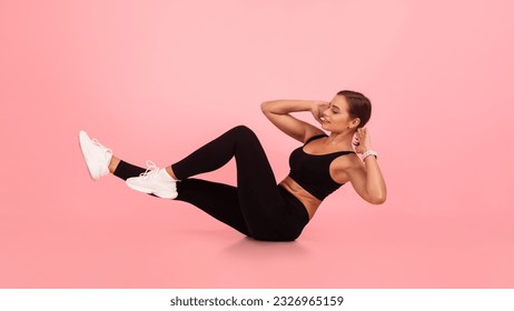 Fitness Workout. Young Woman Doing Bicycle Crunch Abs Exercise Over Pink Studio Background, Motivated Millennial Female In Sportswear Working Out Core Muscles, Enjoying Healthy Lifestyle - Shutterstock ID 2326965159