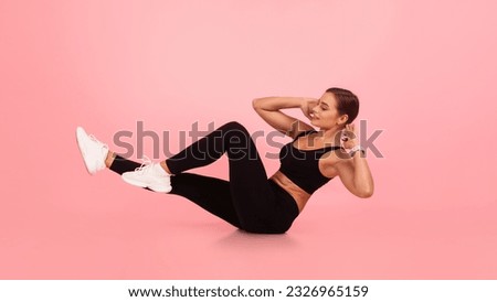 Fitness Workout. Young Woman Doing Bicycle Crunch Abs Exercise Over Pink Studio Background, Motivated Millennial Female In Sportswear Working Out Core Muscles, Enjoying Healthy Lifestyle