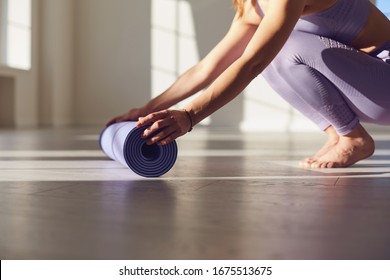 Fitness yoga exercise workout woman. A woman with a yoga mat in a white room in a bright room.