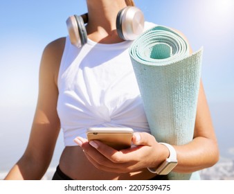 Fitness, Yoga And Woman On A Phone In Nature, Texting And Listening To Music Before Summer Outdoor Workout. Radio, Podcast And Wellness Exercise With Female Relax While Searching For Online Playlist