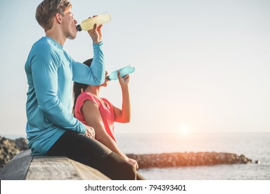 Fitness Young Couple Drinking Energy Drink Outdoor - Sporty People Rest And Hydrate The Body After Training Workout Session - Healthy Lifestyle And Jogging Concept - Focus On Man Face