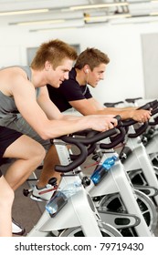 Fitness Young Man On Gym Bike Indoor Cardio Exercise