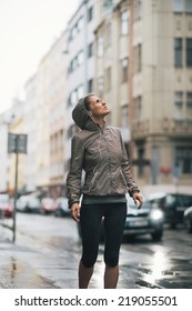 Fitness Young Woman Exposed To Rain While Jogging Outdoors In The City