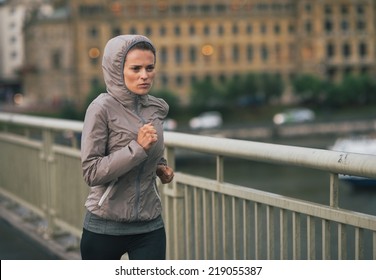 Fitness Young Woman Jogging In Rainy City