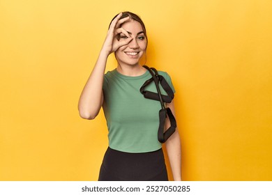 Fitness young woman with resistance bands excited keeping ok gesture on eye. - Powered by Shutterstock