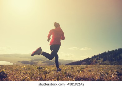 Fitness Young Woman Trail Runner Running On Beautiful Mountain Peak