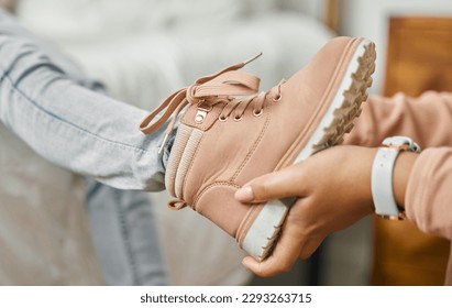 It fits perfectly. an unrecognizable person putting a shoe onto a childs foot at home. - Powered by Shutterstock