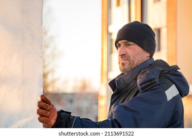 Fitter In A Blue Hooded Jacket At An Ice Slab Installation