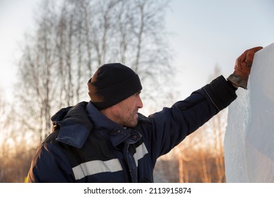 Fitter In A Blue Hooded Jacket At An Ice Slab Installation